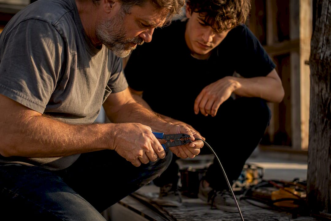 Hands guiding tool use on site
